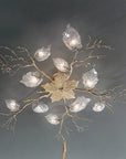Ceiling light fixture with leaf and branch design on a dark background