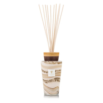 A decorative Baobab diffuser with wooden sticks and a white background.