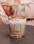 A Baobab Women Candle Max 10 MAX10WOM is sitting on a table next to a couch.