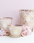 Three Baobab Women Candle Max 10 MAX10WOM candle holders with pink flowers on them, perfect for women who enjoy scented candles. Additionally, a percentage of the purchase will be donated to breast cancer research.