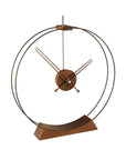 A Nomon Aire AIR circular ring wooden clock on a wooden stand.