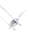 A Nomon wall clock with an avant-garde design featuring two swords: the Clock Nomon Axioma i 60 AXI.