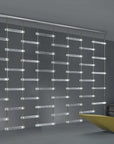 A room with a yellow chair and a glass wall featuring an Italamp Piola lighting fixture adorned with cast glass bars.
