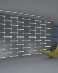 A room with a yellow chair and a glass wall featuring an Italamp Piola lighting fixture adorned with cast glass bars.