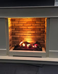 White fireplace mantle with a brick insert and glowing fire from artificial water vapour fireplace