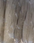 A close up of LCD Textiles' LCD Metal Fabric Ribbon Collection featuring light and silver hues.
