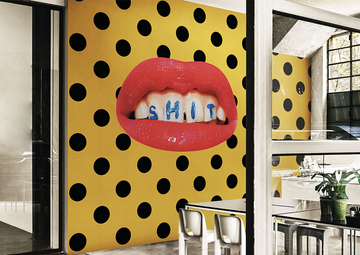 A luxury dining room with Londonart Toilet Paper Wash Your Mouth yellow and black polka dot wallpaper.