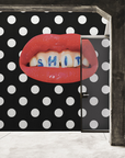 A luxury black and white polka dot wallpaper, reminiscent of a Londonart Toilet Paper Wash Your Mouth pattern, adorned with a lipstick silhouette.