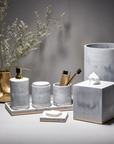 Marble bathroom accessories from the SV Casa Toro Collection featuring gold accents.