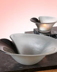 Maleras Crystal Magic Silver Bowl with other small bowl on wooden table with light orange back ground for modern interiors available at Spacio India from Decor Accessories and Tableware Collection of Decorative Bowls.