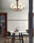 A dining room with a table, chairs, and a Masiero Tee Chandelier.