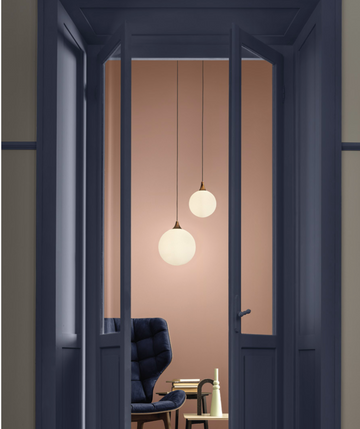 A doorway adorned with a Masiero Tee Pendant Lamp, creating a captivating and luxurious ambiance.