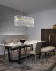 A modern dining room with Masiero Vegas Chandelier lights and chairs.