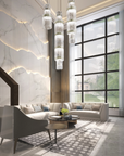 A modern living room with marble floors adorned with Masiero Vegas Chandeliers providing decorative lighting reminiscent of Las Vegas.