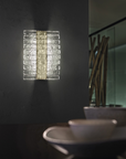 A Masiero Vegas Wall Sconce in a dining room that adds opulence to your space.