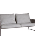 A grey Sifas Basket outdoor sofa with waterproof properties, set against a white background.