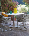 A Sifas waterproof outdoor furniture set consisting of a table and chairs, perfect for the garden.