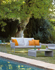 The Sifas Basket Sofa Collection, a outdoor furniture collection featuring waterproof properties, is perfect for lounging near a swimming pool.