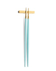 Cutipol Goa turquoise matt gold finish, black resin handles, and minimalist design for a luxurious dining experience - on a white background chopsticks with chopstick rest