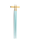 Cutipol Goa turquoise matt gold finish, black resin handles, and minimalist design for a luxurious dining experience - on a white background chopsticks with chopstick rest