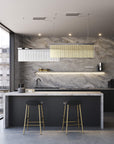 Discover the Carmen collection by Italamp – Italian Murano glass lighting in clear, smoke, and teak finishes. Elegant designs for luxurious interiors. A rectangular suspension of 2 pcs in teak and clear finish over a kitchen pantry counter in a luxury interior