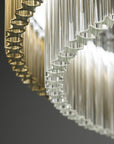 Bottom view of the teak and clear glass chandelier. Discover the Carmen collection by Italamp – Italian Murano glass lighting in clear, smoke, and teak finishes. Elegant designs for luxurious interiors.
