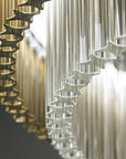 Bottom view of the teak and clear glass chandelier. Discover the Carmen collection by Italamp – Italian Murano glass lighting in clear, smoke, and teak finishes. Elegant designs for luxurious interiors.