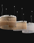 A close view with teak and clear glass in spiral shape. Discover the Carmen collection by Italamp – Italian Murano glass lighting in clear, smoke, and teak finishes. Elegant designs for luxurious interiors.