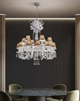 Chanel Collection chandelier by Italamp with carved crystal, chrome-finished metal, and dove fabric diffusers, showcasing Italian luxury and timeless design. The chanel chandelier above a marble top dining table in a luxury modern interior