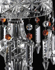 Close-up of a crystal chandelier with hanging crystals against a black background