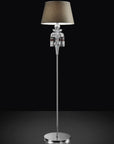 Decorative floor lamp with crystal details and a dark shade on a black background from Italamp available at Spacio in India