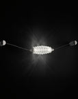 Colier collection by Italamp, featuring modular blown glass elements in vibrant colours and shapes, designed by Marc Sadler to create magical lighting effects. A white colour wall sconce on a dark colour wall.