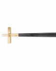 Cutipol Kube cutlery collection with straight-line designs in matte brushed and gold-plated finishes, showcasing Portuguese craftsmanship for elegant dining settings - a pair of black gold chop sticks with stand