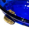 A stunning Mario Cioni Purpose Blue Gold Walnut Crystal Bowl with deep blue crystal, gold walnut accents, and intricate engraved leaf patterns, handcrafted in Italy.