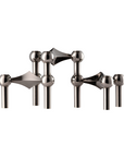 A set of polished chrome candle stand on a solid white background from Stoff Nagel available at Spacio in India.