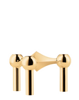 A polished gold three-hole candle stand shown against a solid white background.