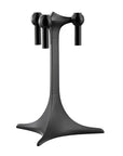 A matte black metal table base with a three-arm design candelabra, featuring spherical finials at the top and a flared tripod-style pedestal base, shown on a solid white background.