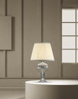 A Venetian glass table lamp with cream colour fabric shade on a round coffee table in a modern contemporary luxury interiors