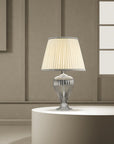 A Venetian glass table lamp with cream colour fabric shade on a round coffee table in a modern contemporary luxury interiors