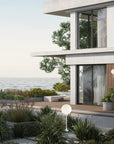 Modern house with ocean view and garden and wall / floor lamps from Masiero