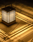 Cylindrical lantern with glowing interior on a textured surface