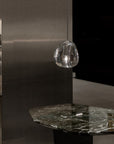 Terzani Mizu Pendant Italian crystal light in clear finish above a marble side table in a contemporary look interiors. Available at Spacio retail stores in Mumbai & Kolkata.