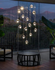 Terzani Mizu Pendant Italian crystal light installation in a luxury indoor setting with picturesque view of mountains. Available at Spacio retail stores in Mumbai & Kolkata.
