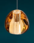 Terzani Mizu Pendant Light Spacio India in cognac finish on a blue background