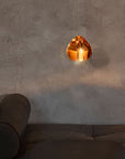 Terzani Mizu Pendant Light Spacio India in cognac finish above an ottoman.
