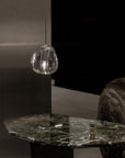 Terzani Mizu Pendant Italian crystal light in clear finish above a marble side table in a contemporary look interiors. Available at Spacio retail stores in Mumbai & Kolkata.