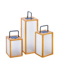 Three rectangular solar lanterns with wooden frames and blue lids on a white background