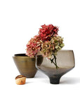 Two decorative vases with flowers on a white background