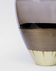 Close-up of a vase with gradient colors on a white background