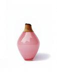 Pink ceramic vase with a wooden cap on a white background from Utopia & Utility available at Spacio retail stores in Mumbai & Kolkata.